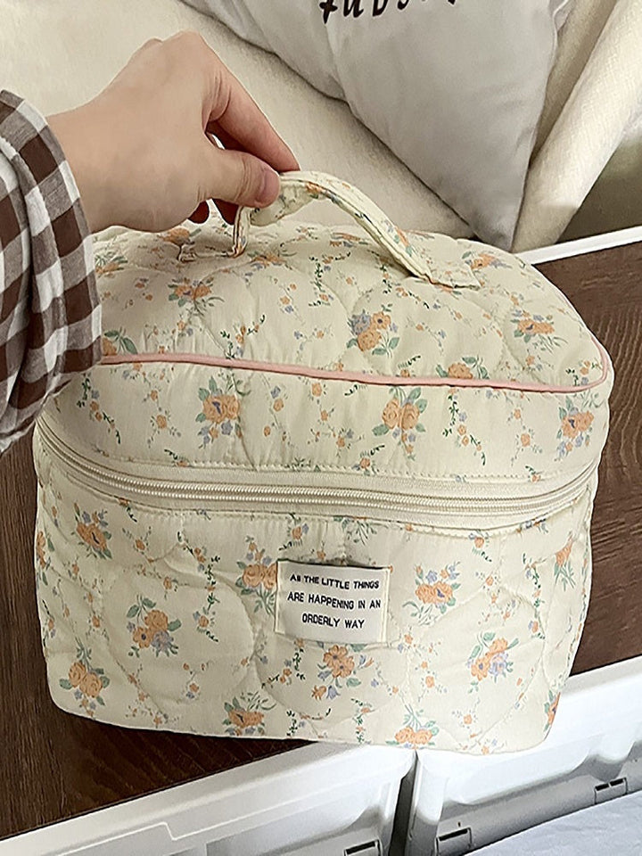 Bolsa de maquiagem floral cremosa