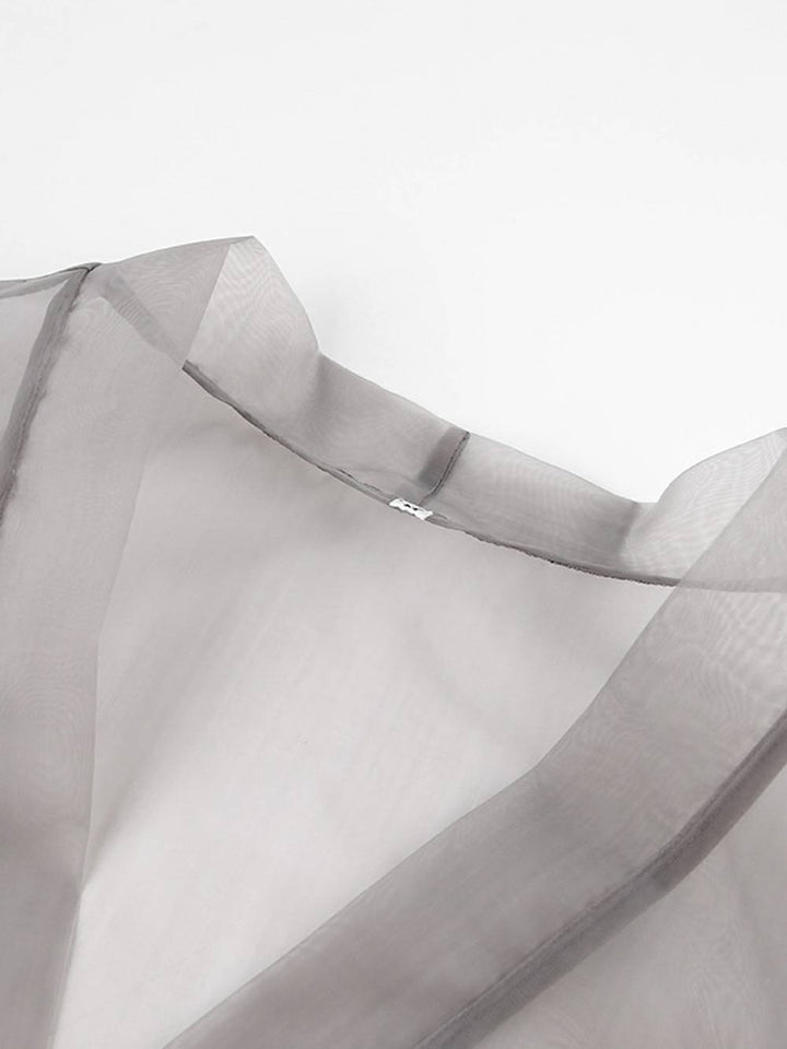 Przezroczysta seksowna bluzka z dekoltem w kształcie litery V, długimi bufiastymi rękawami i kokardką