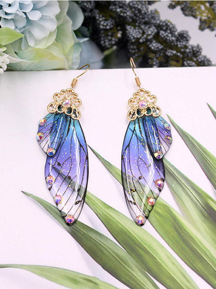 Kolczyki z kryształowymi skrzydłami motyla i niebieskimi kryształami Cykada
