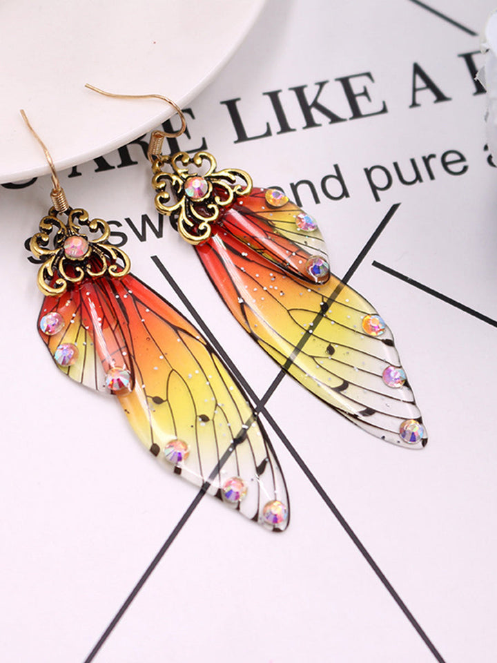 Kolczyki z kryształowymi skrzydłami motyla i żółtymi kryształkami cykady